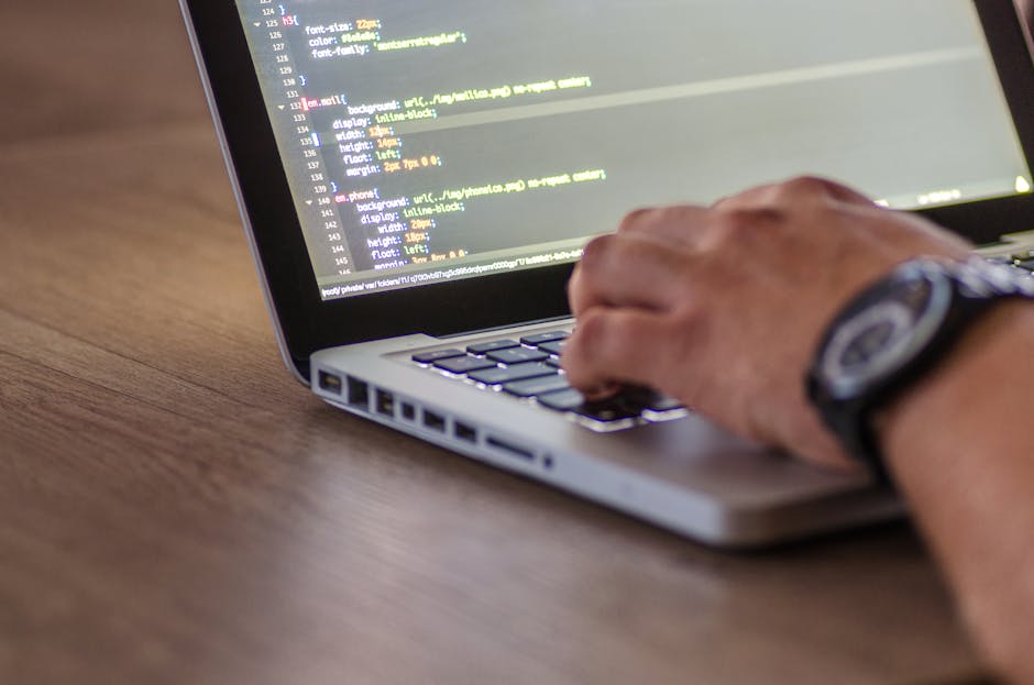 A close-up view of a computer screen displaying lines of colorful code in a text editor, with a focus on scripting language syntax highlighted in bright pink, green, blue, and white. The background is